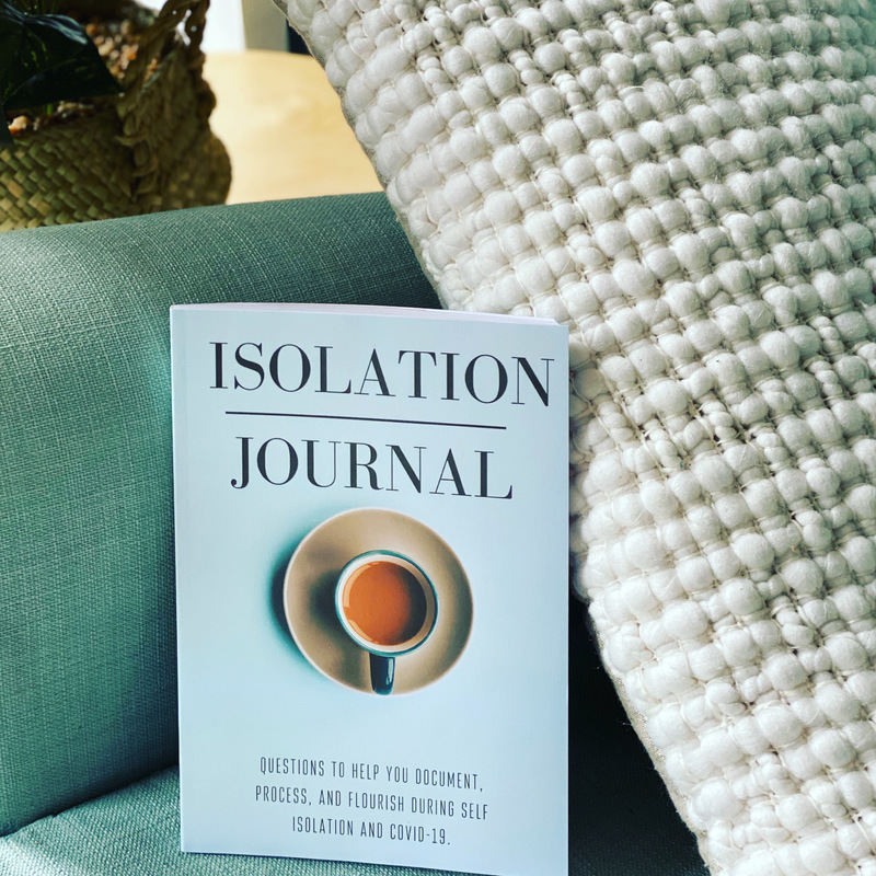 A white journal sitting in a green chair.