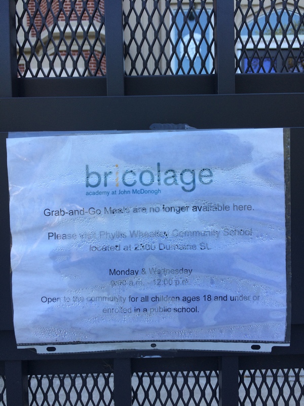 A paper sign on a grated door.