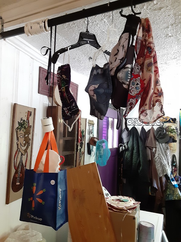 Coat hangers with multiple masks on them.