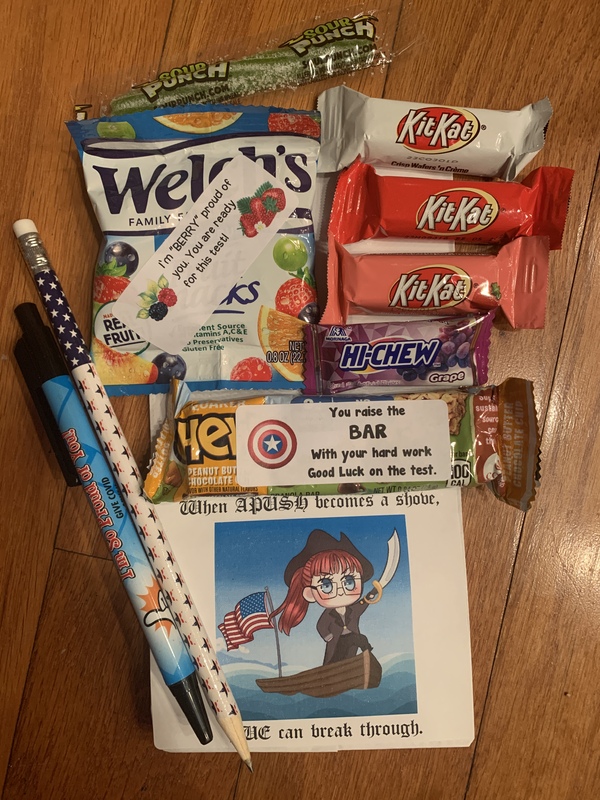This is a picture taken of a group of snacks that were from a gift bag. Several encouraging messages are also found on slips of paper mixed with the snacks.