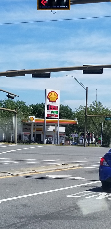A Shell gas station sign that has the price $1.99 on the sign.