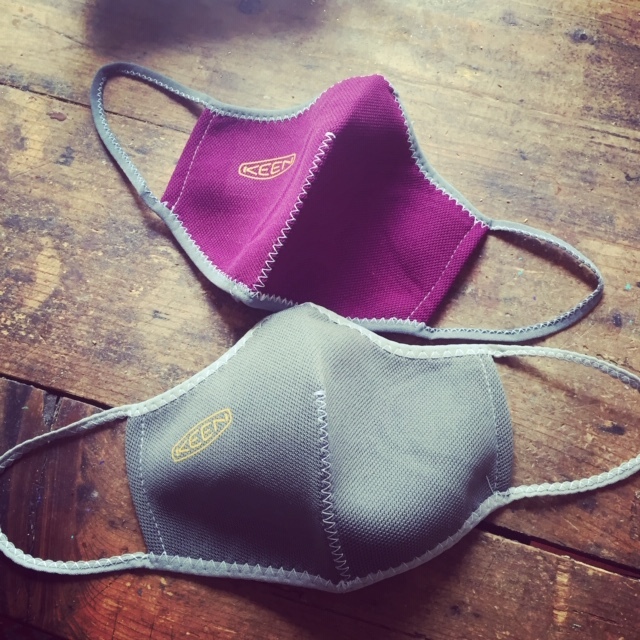 A gray face mask and a purple face mask.