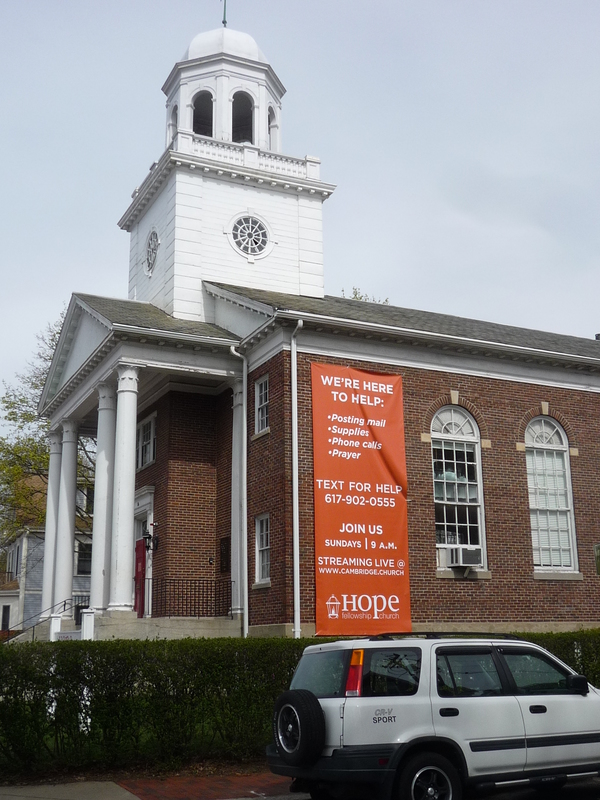 A banner on the side of a church. 