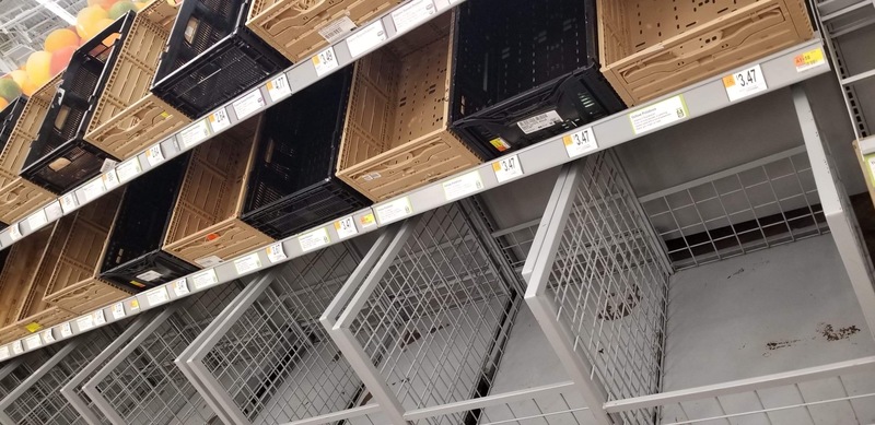 Empty shelves and baskets in a supermarket.