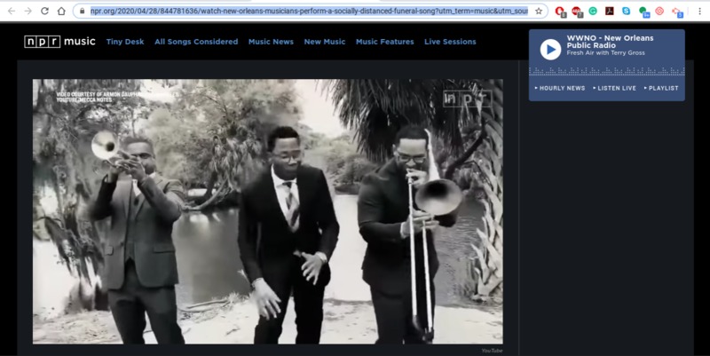 Screenshot of "NPR Music: WWNO - New Orleans Public Radio: Fresh Air with Terry Gross" with a black and white photo of three musicians in suits and ties: one playing trumpet (left), one playing trombone (right), and the other is singing (middle). There is foliage behind them.