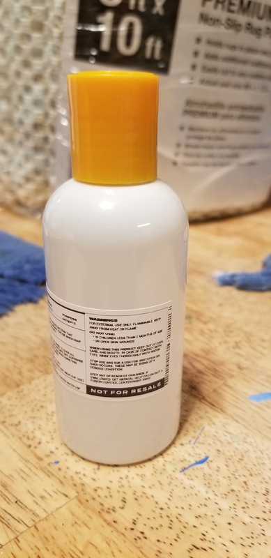 A orange and white hand sanitizer bottle.