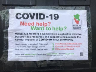 A white sign with green and red text.