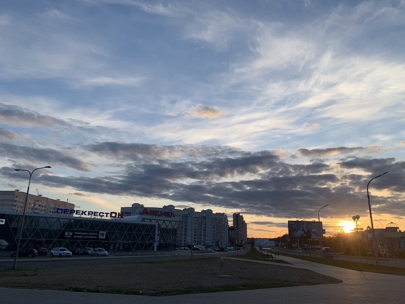 Buildings in front of a setting sun.
