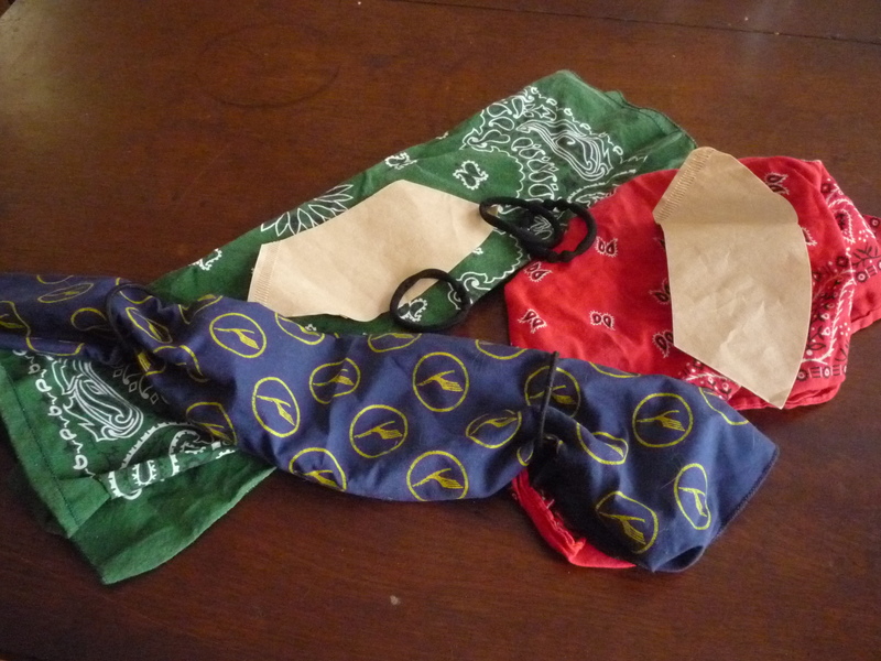 Bandanas, coffee filters, and hair ties on a table.