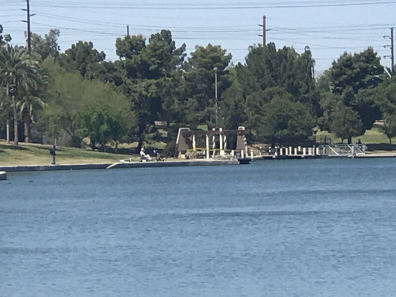 Photograph of people fishing at a lake.