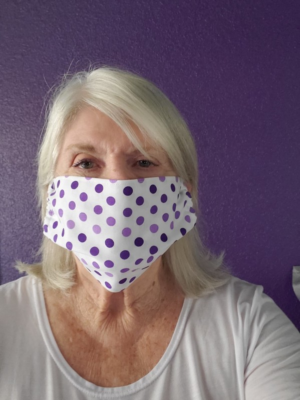 A person wearing a polka dot mask. 