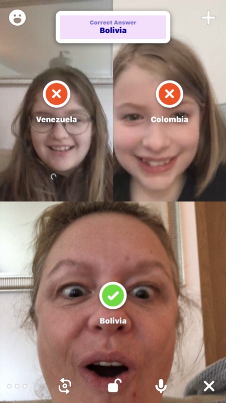 Three people playing a game through a video phone call.