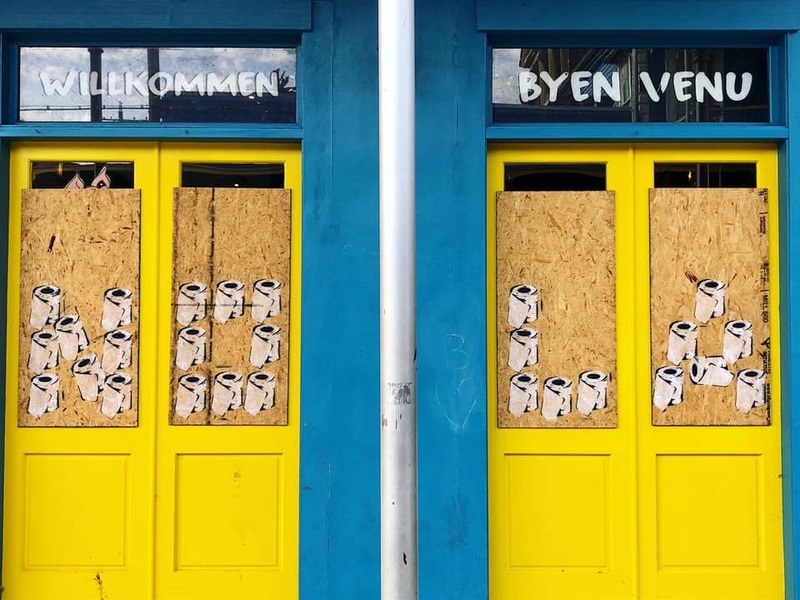 Art of toilet paper on two doors.