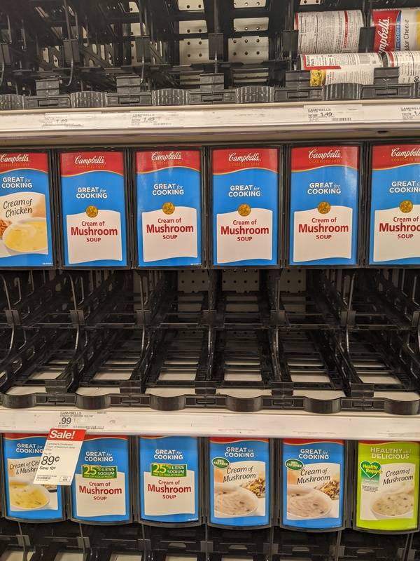 An empty stand made to hold cans of soup.
