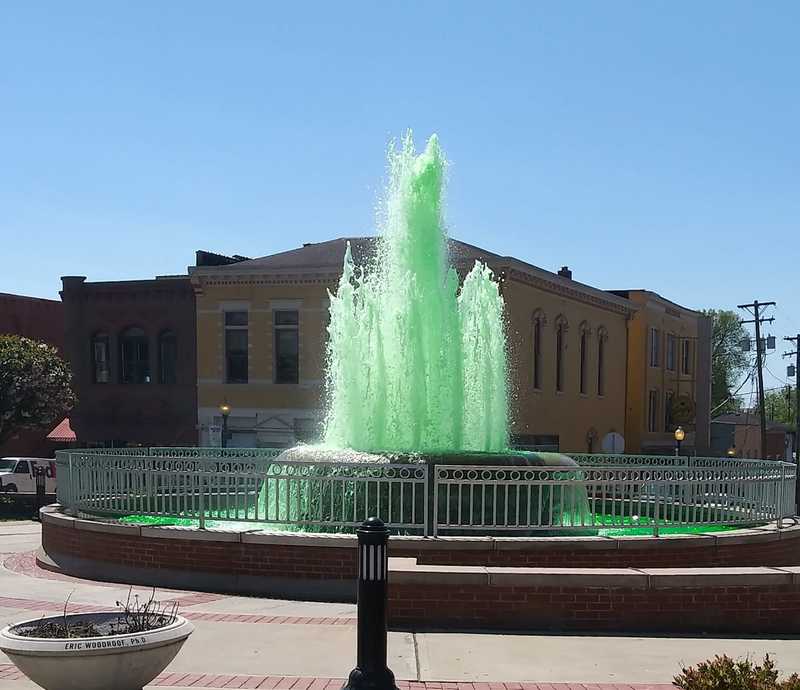 A fountain with green water.