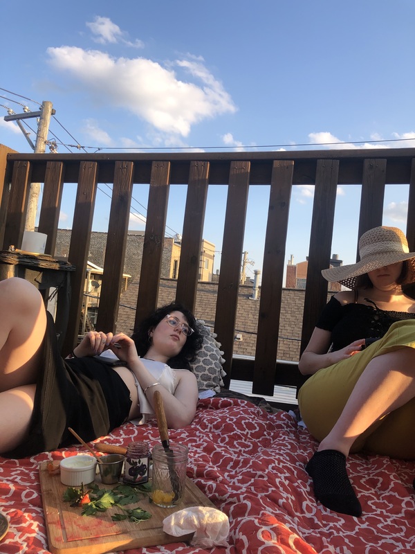 Two people laying on a blanket.