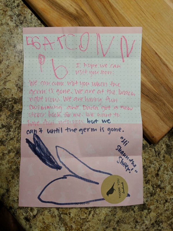 A pink letter with pink writing on it.