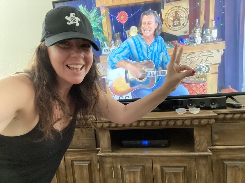 A person posing for a picture in front of their tv. 