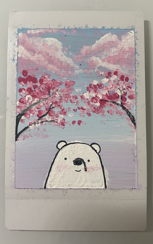 A photo of painting of a white bear standing under Cherry Blossom Trees.