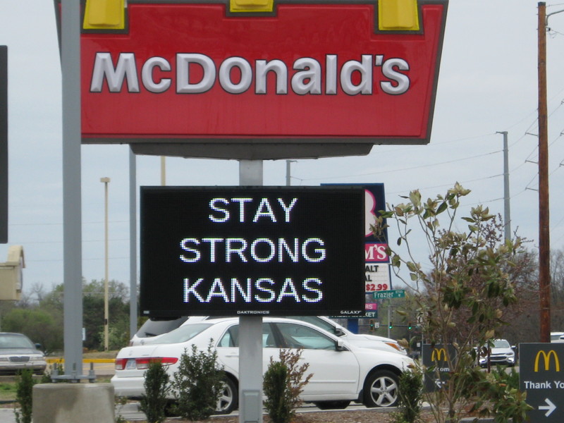 A sign under a McDonald sign stay "stay strong Kansas"