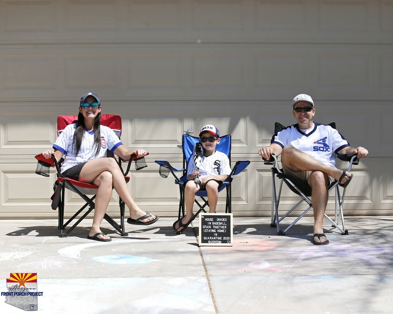 A family sitting on lawn chairs.