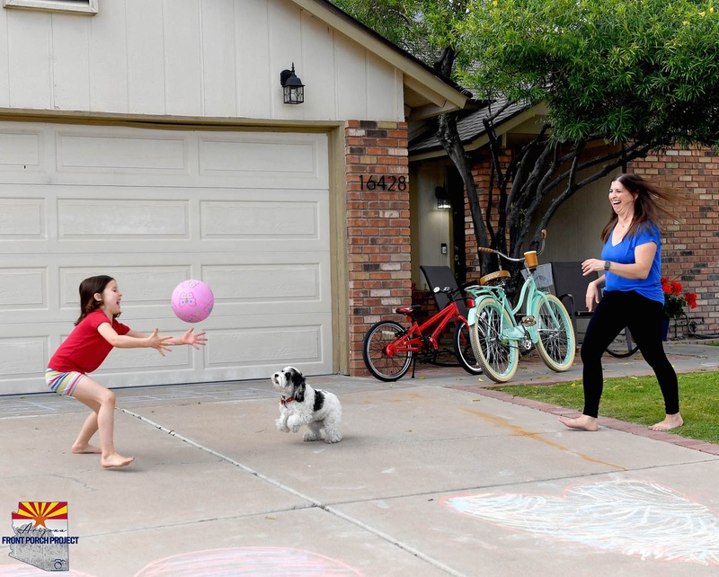 A family playing in their front yard.