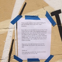 A notice within a community that is letting others know that a resident lost a loved one, and to not remove things from the altar that was created.