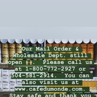 Screenshot of a Facebook post by Café Du Monde that informs patrons that their mail order and whole department are still open.
