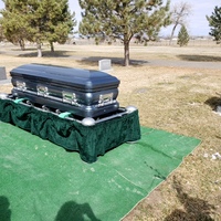 This is a picture taken of a coffin laid to rest at a funeral.