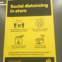 Yellow paper with text, "Social distancing in store." There are four pictures about how to social distance. First one has two people and a trolley measuring 1.5 meters distance between them. Second shows floor markings that will be throughout the store. Third asks to pack the bags you brought from home. Fourth asks you tap to pay when possible. Text at bottom says, "If you should be in self-isolation, we ask that you respect our team and customers by not visiting our store."