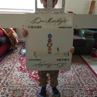 A liquor store box repurposed for a child's arts and craft project.