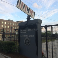 The entrance for the New Orleans Center for Creative Arts decorated with black ribbon.