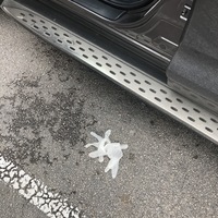 A disposable glove is on the ground in a parking lot.