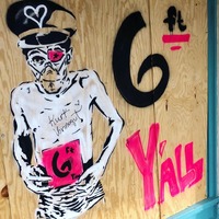 Street art of a man holding a sign.