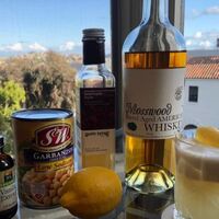 A cocktail and the ingredients used to make it.