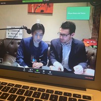 A laptop shows a Zoom meeting on the screen.