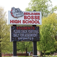 A school sign reading "Students, Please Check Your Email Daily for Assignment Updates".