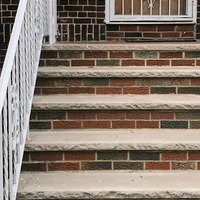 a sign tied to a door encouraging people to stay strong during corona virus