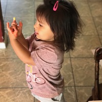 A child with paint on their fingers.