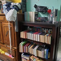 This is a picture of a very full bookshelf.