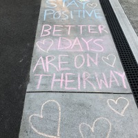Message written in chalk on the sidewalk.