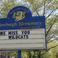 An elementary school sign reading "We Miss You Wildcats".