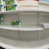 A row of shelves with paper towels stacked on top of them.