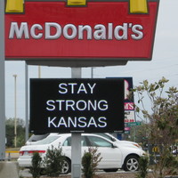 A sign under a McDonald sign stay "stay strong Kansas"