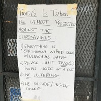 A piece of paper is taped on the front of a door to a store and says: FRADY'S IS TAKEN THE UTMOST PROTECTION AGAINST THE CORONAVIRUS: 1) EVERYTHING IS CONTINUALLY WIPED DOWN WITH BLEACH AND WATER. 2) PLEASE LIMIT TWO (2) PEOPLE INSIDE AT A TIME. 3) NO LOITERING. 4) NO OUTSIDE/INSIDE DINING.