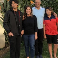 A picture of a family of four outside.