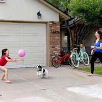 A family playing in their front yard.